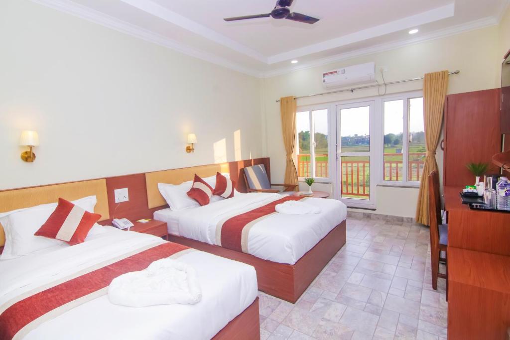 Postel nebo postele na pokoji v ubytování Hotel Yatra Sauraha Pvt Ltd