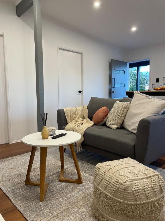 a living room with a couch and a table at Serene Haven in Sanctuary Point in Sanctuary Point