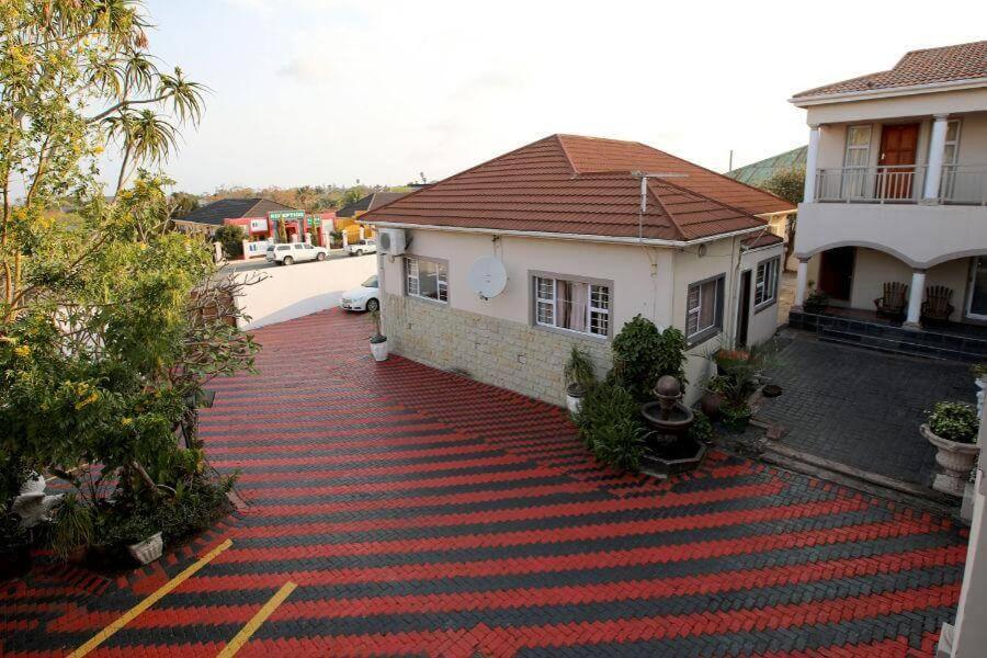 a house with a red carpet in front of it at The Rest Place B&B in East London