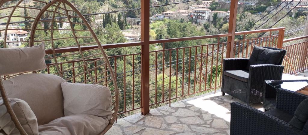 a balcony with chairs and a view of a mountain at family home in Dhimitsana