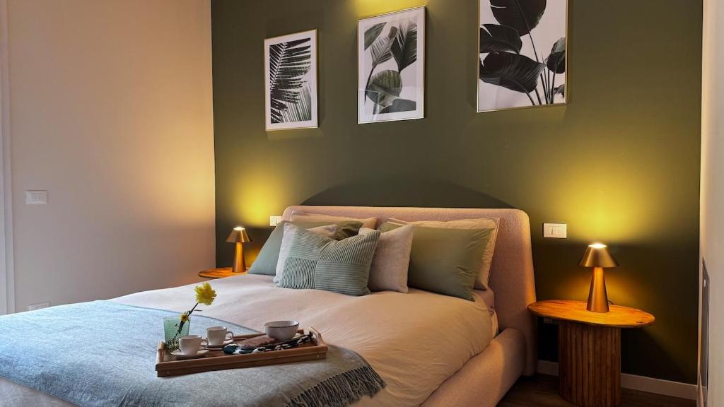 a bedroom with a bed with a tray on it at Brighter Days - Two-room apartment with lake view and pool in Predore