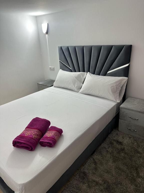 a large bed with two purple pillows on it at Loft Apartament Chaouen in Chefchaouen