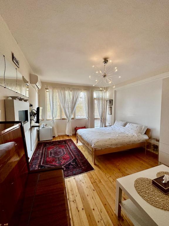 a bedroom with two beds and a living room at Mary's Guesthouse in Banya