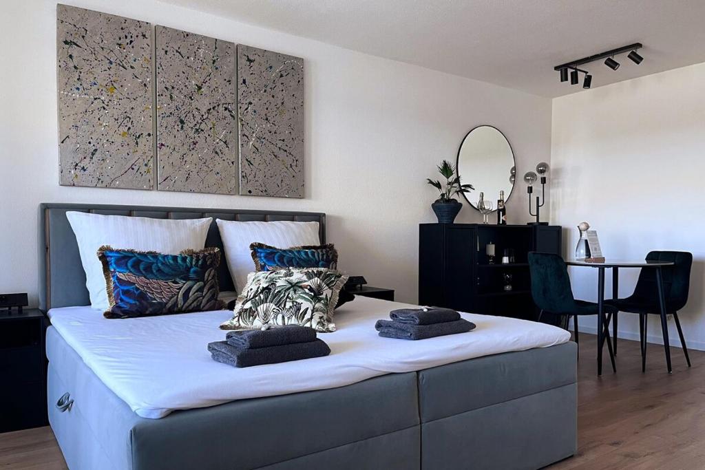 a bedroom with a large bed and a table at Apartment mit Grüner Aussicht im Schwarzwald in Löffingen