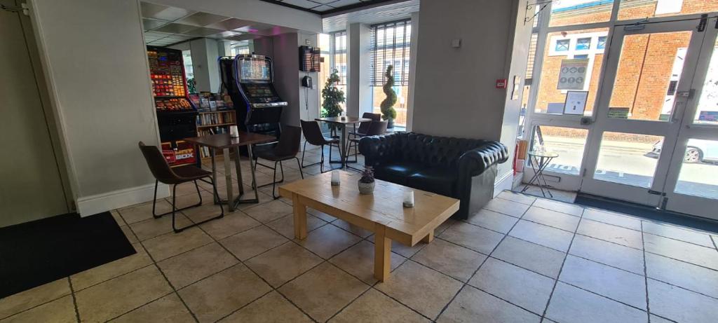 a living room with a couch and a coffee table at The Arncliff Hotel in Blackpool