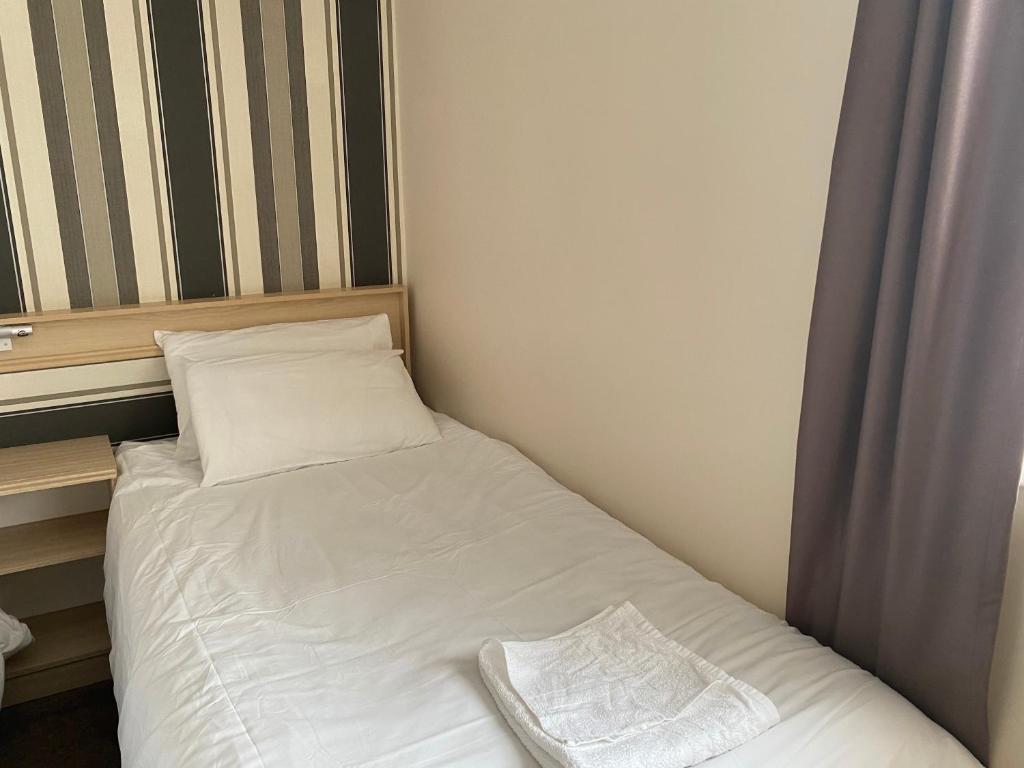 a small bed in a small room at The Arncliff Hotel in Blackpool