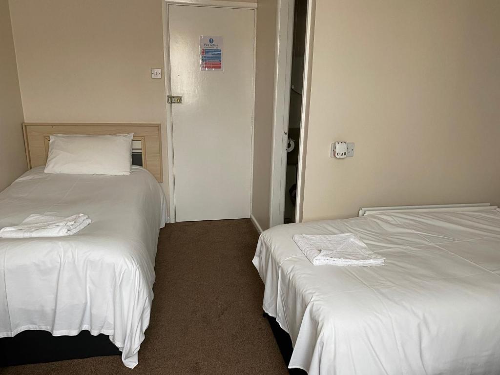 two beds sitting next to each other in a room at The Arncliff Hotel in Blackpool