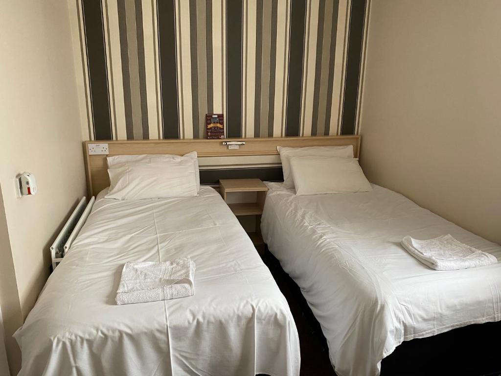 two beds sitting next to each other in a room at The Arncliff Hotel in Blackpool