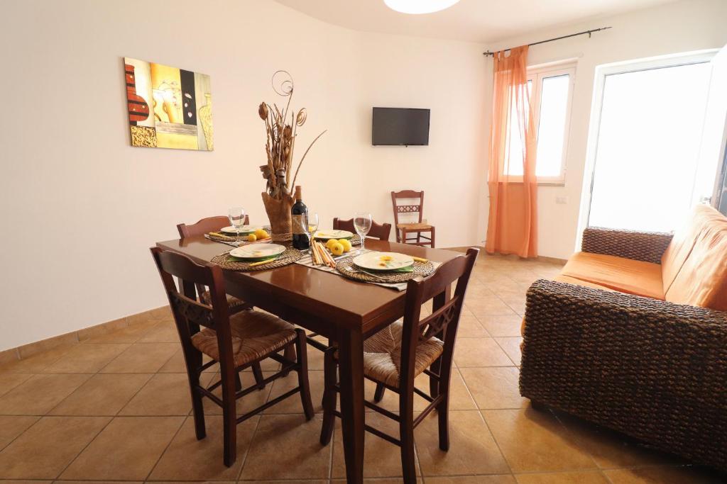 a dining room with a table and chairs at Casa Samira Otranto Near Sea and Old Town AC, WiFi, 4 Guests in Otranto