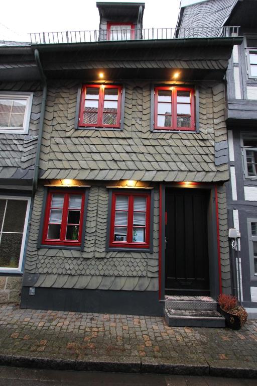 a house with red windows and a black door at Ferienhaus Charlotte in Goslar