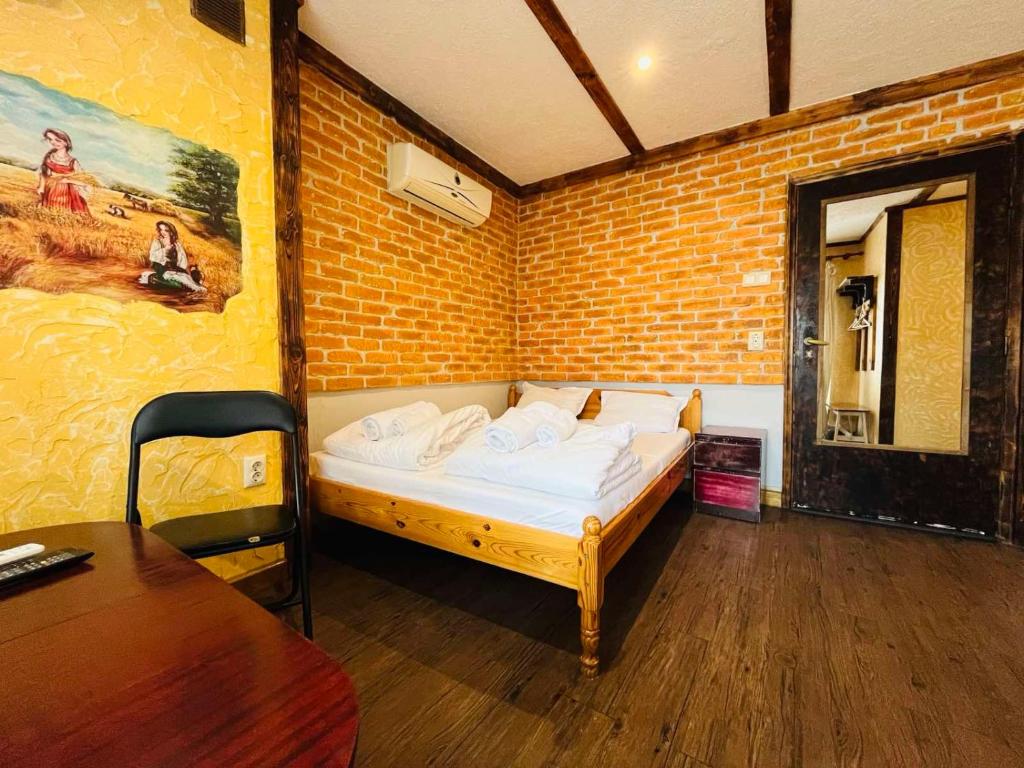 a bedroom with a bed in a brick wall at Rooms43 in Sofia