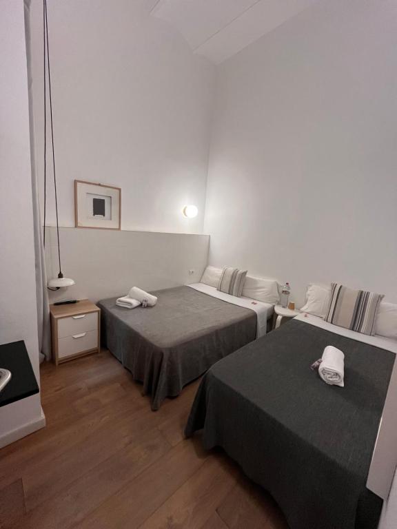 Posteľ alebo postele v izbe v ubytovaní Hostal Argo