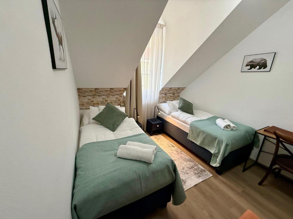 A bed or beds in a room at Penzión U Srnčíka
