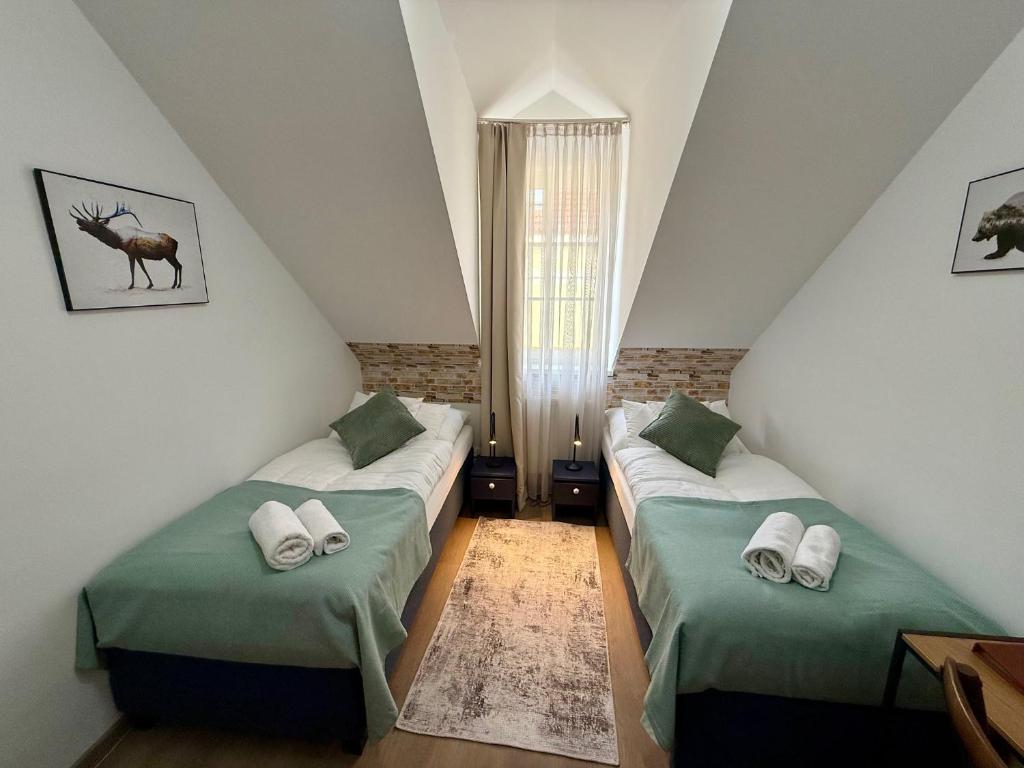 A bed or beds in a room at Penzión U Srnčíka