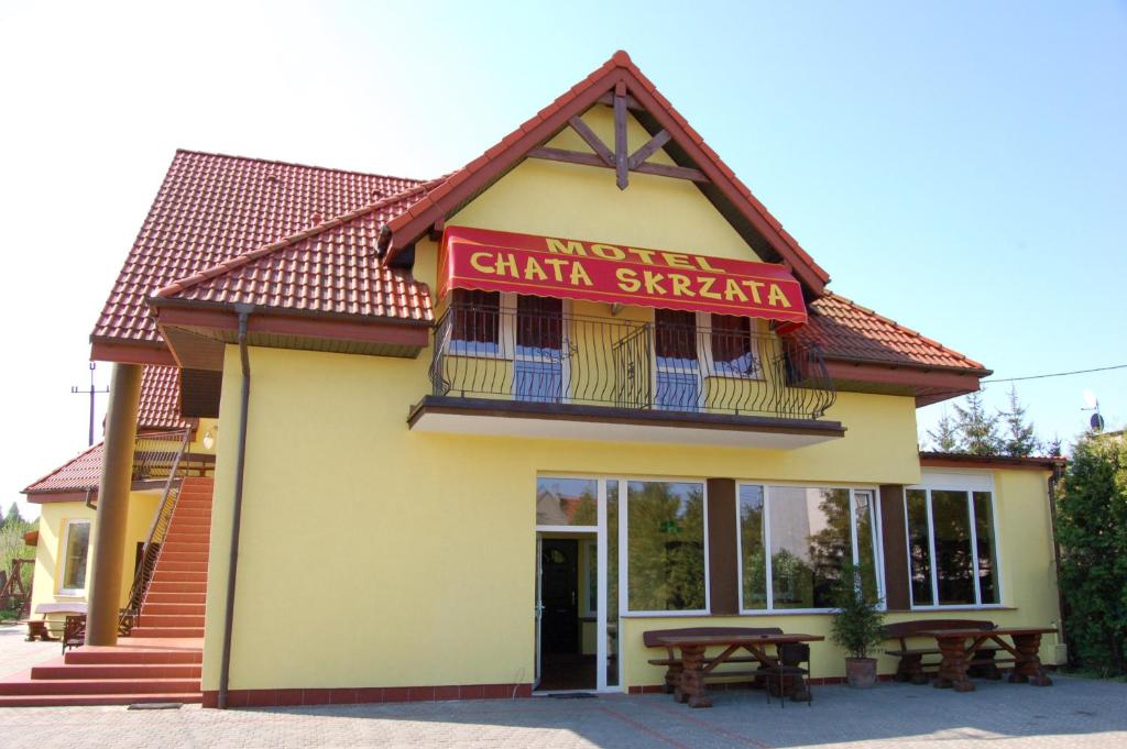a building with a sign that reads merely chandan sharma at Chata Skrzata in Kruszyn