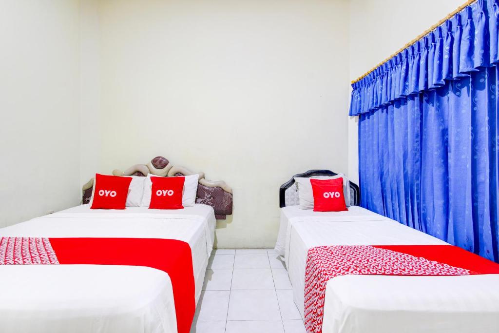 Postel nebo postele na pokoji v ubytování Hotel O Jalan Malioboro Near Stasiun Tugu Yogyakarta Formerly Hotel Baru