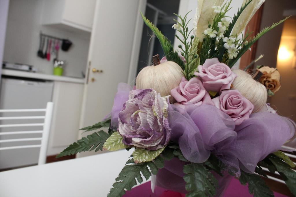 a bouquet of purple roses and other flowers at Lofts In Rome in Rome
