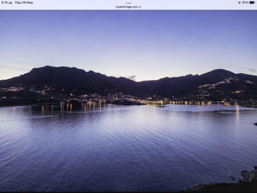 a view of a large body of water with mountains at Astrio Suites in Livadi