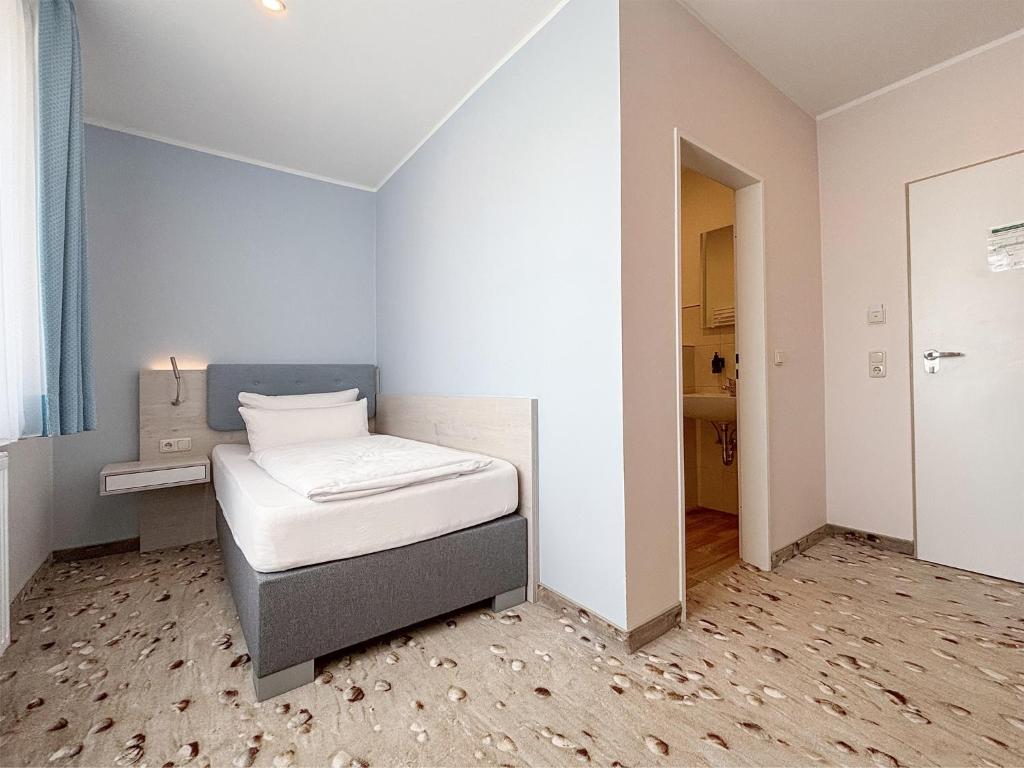 Postel nebo postele na pokoji v ubytování DORMERO Hotel Wilhelmshaven