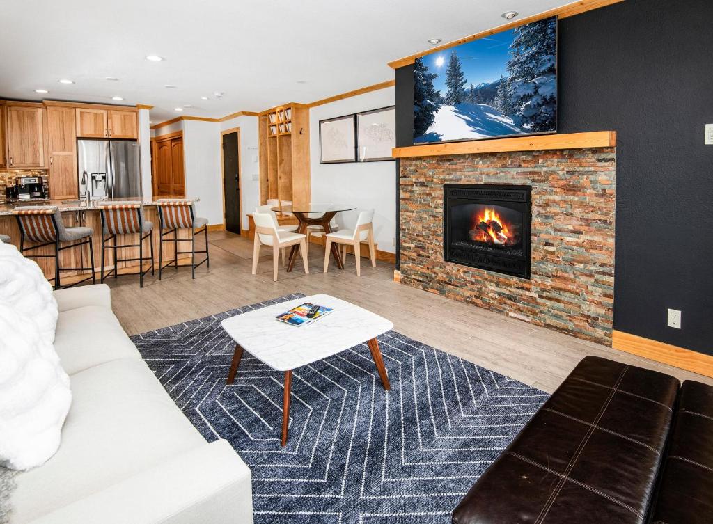 a living room with a couch and a fireplace at Seasons 219 in Avon