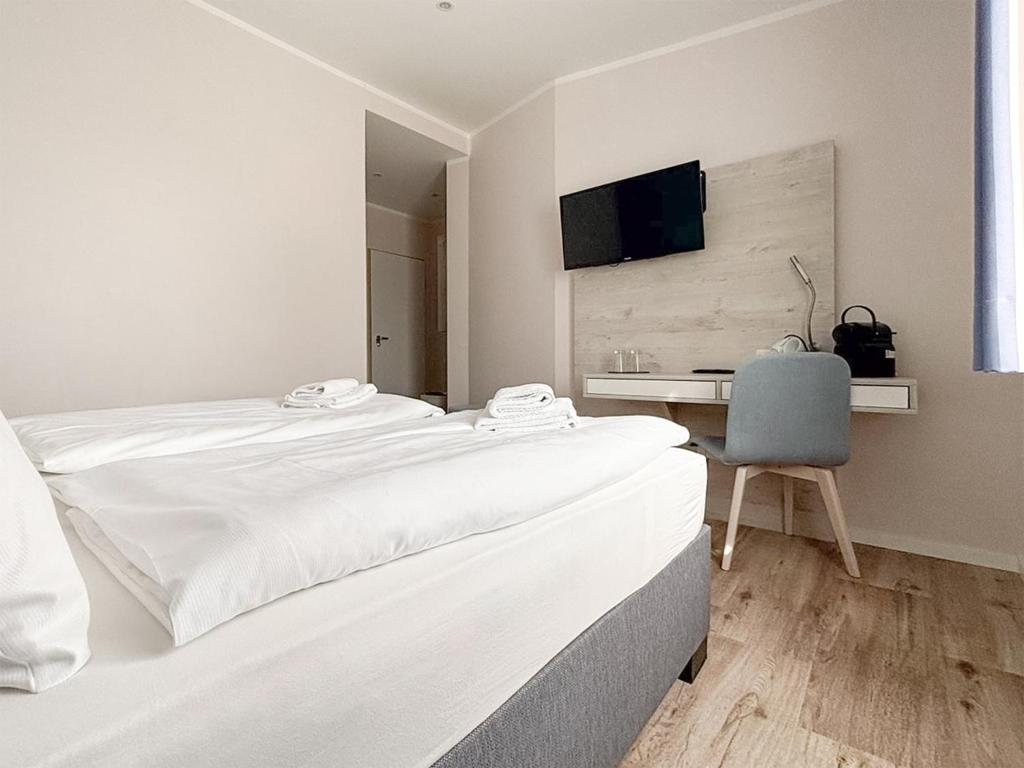 Postel nebo postele na pokoji v ubytování DORMERO Hotel Wilhelmshaven