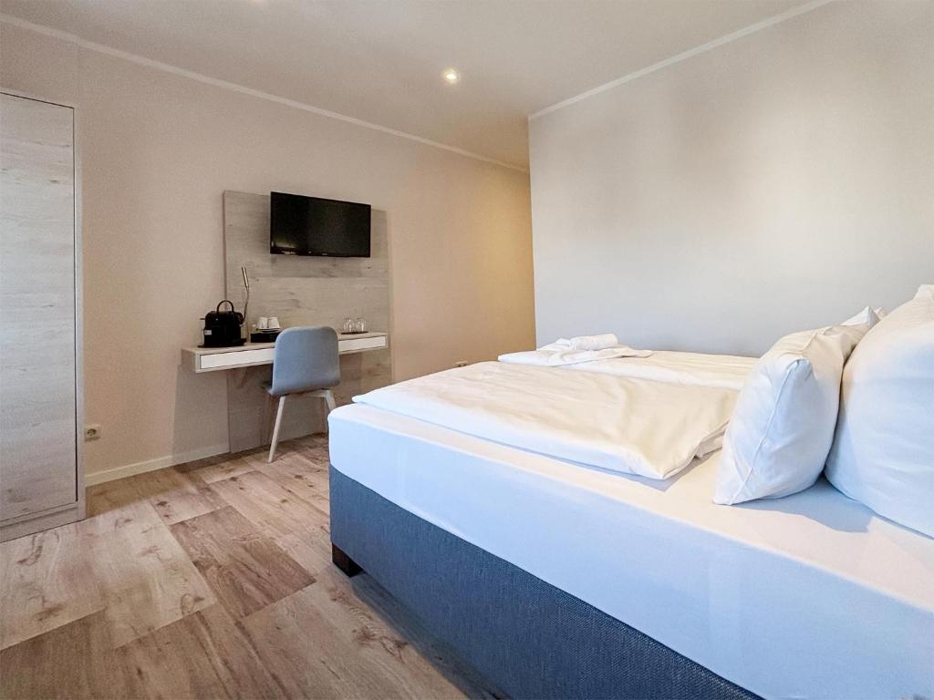 Postel nebo postele na pokoji v ubytování DORMERO Hotel Wilhelmshaven