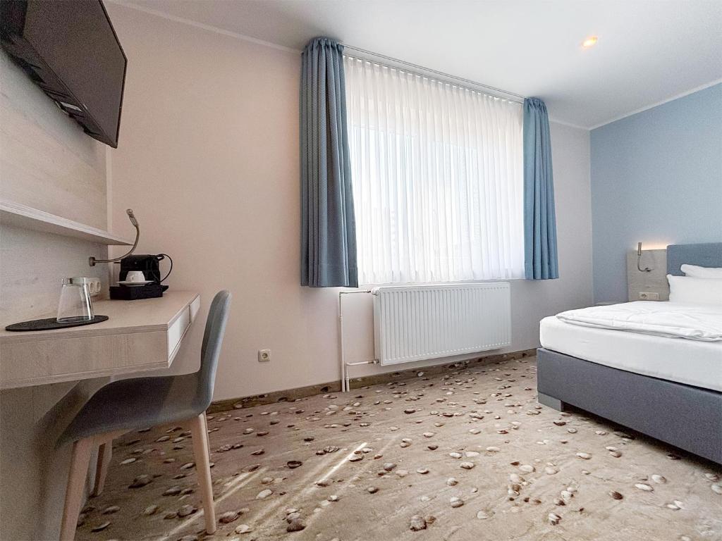 Postel nebo postele na pokoji v ubytování DORMERO Hotel Wilhelmshaven