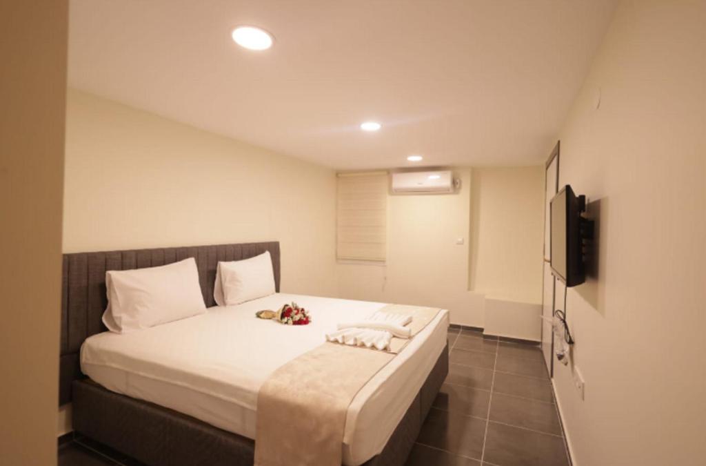 a bedroom with a bed with two towels on it at Pekin Spa and Suites in Istanbul