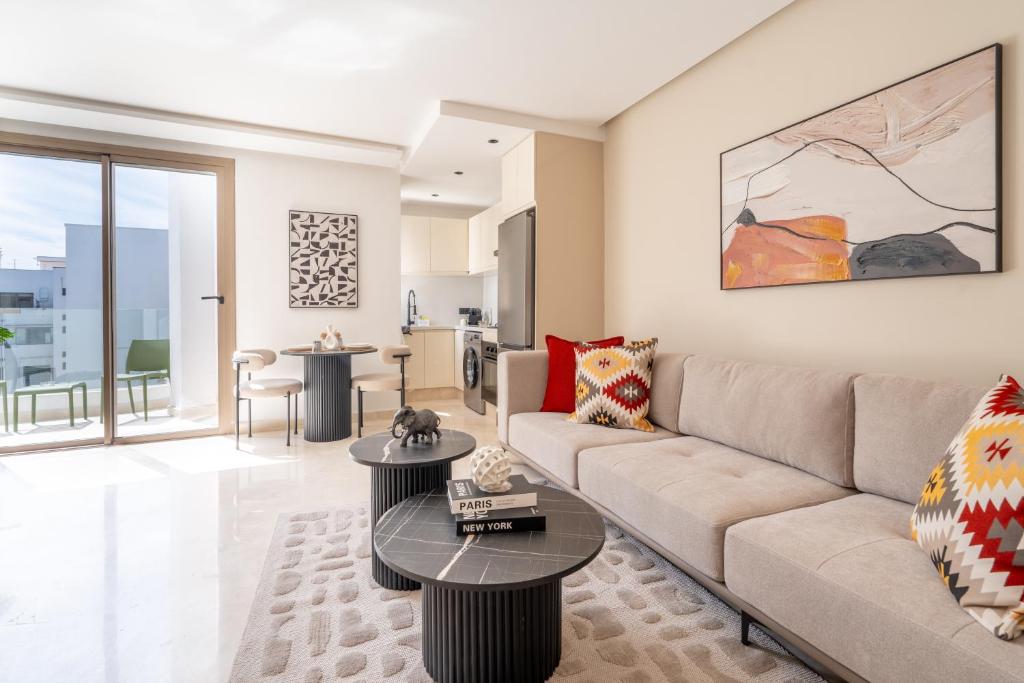 a living room with a couch and a table at Modern & bright studio Balcony & Parking Maarif in Casablanca