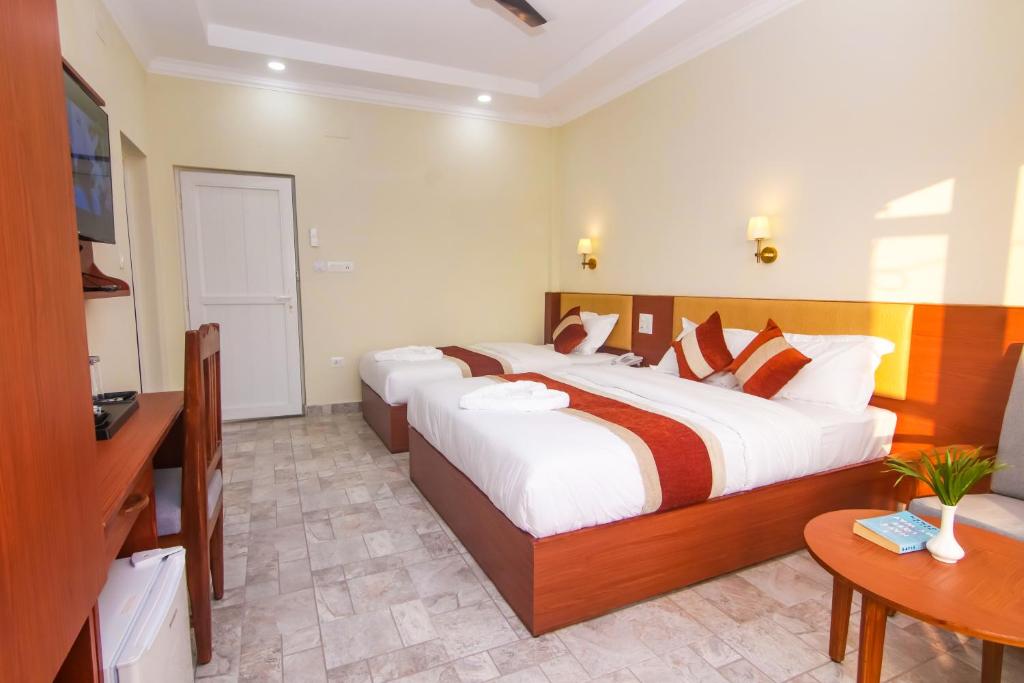 Postel nebo postele na pokoji v ubytování Hotel Yatra Sauraha Pvt Ltd