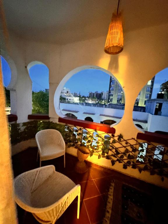 a room with a large window with a view of a ship at A private room in,Coastal Bliss homestsy in Mombasa