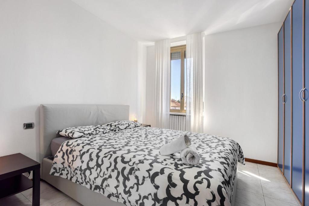 a bedroom with a bed with a cat laying on it at La dimora del Gallo in Concorezzo