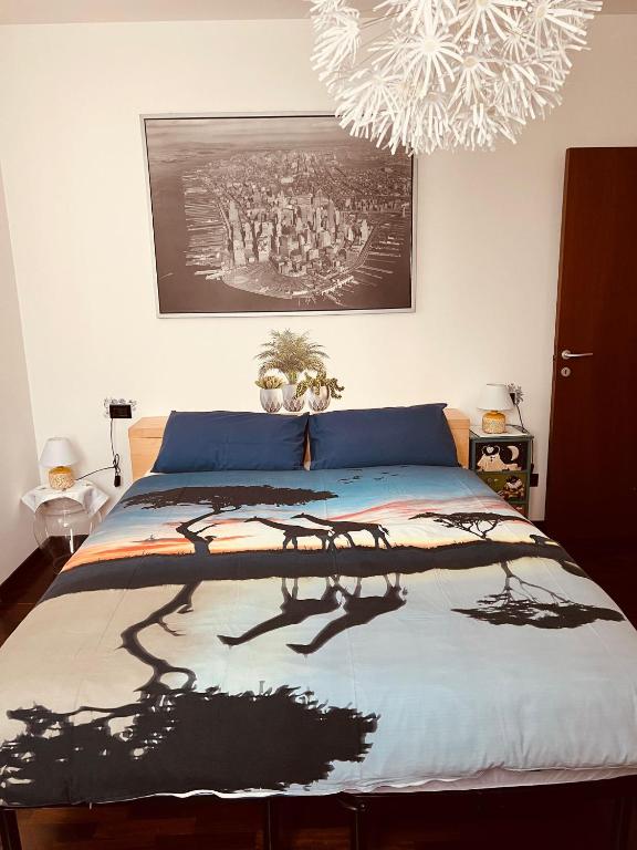 a bedroom with a bed with a painting on the wall at Casa Giulia in Cantù