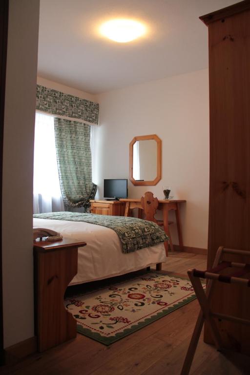 Postel nebo postele na pokoji v ubytování Garnì Valdan