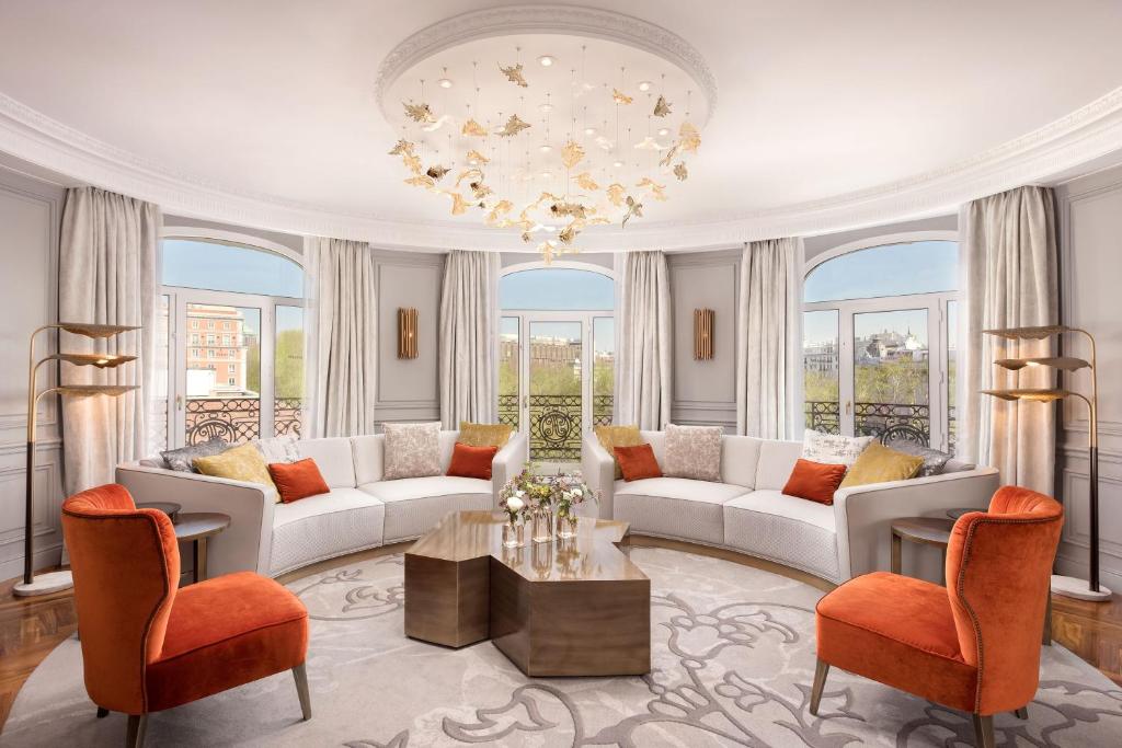 a living room with white furniture and a chandelier at The Palace, a Luxury Collection Hotel, Madrid in Madrid