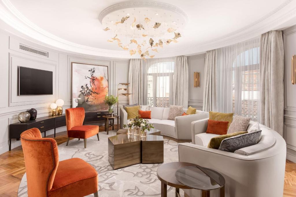 a living room filled with furniture and a chandelier at The Palace, a Luxury Collection Hotel, Madrid in Madrid