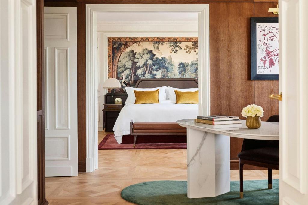 a bedroom with a bed and a table at The Palace, a Luxury Collection Hotel, Madrid in Madrid