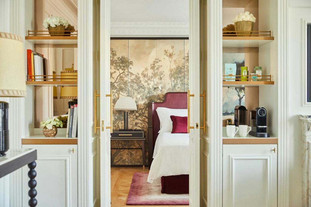 a room with a bedroom with a bed and shelves at The Palace, a Luxury Collection Hotel, Madrid in Madrid
