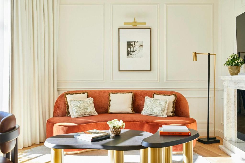 a living room with a couch and a table at The Palace, a Luxury Collection Hotel, Madrid in Madrid