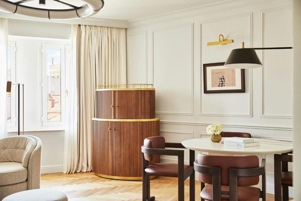 a living room with a table and chairs at The Palace, a Luxury Collection Hotel, Madrid in Madrid