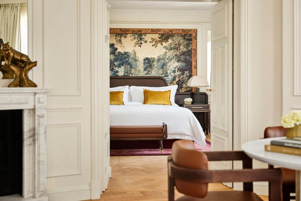 a bedroom with a bed and a painting on the wall at The Palace, a Luxury Collection Hotel, Madrid in Madrid