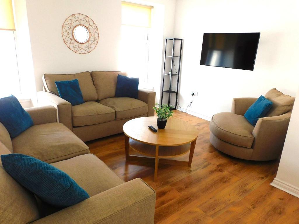 a living room with two couches and a table at No 5 - Modern 2 bedroom Apartment in Lanark Town Centre in Lanark