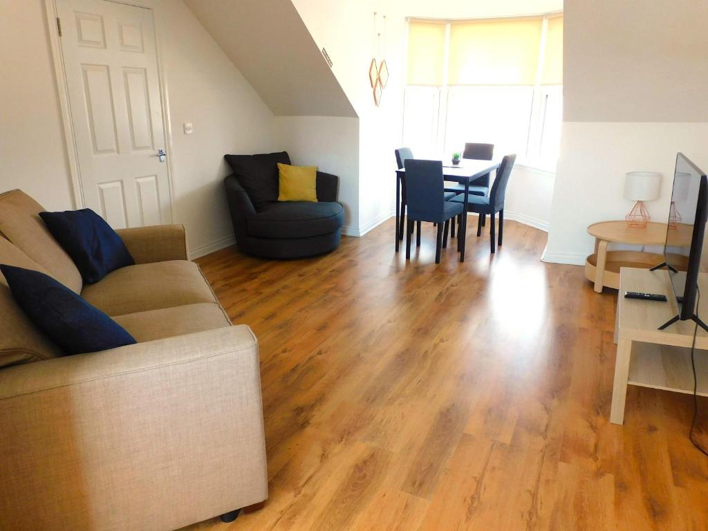 a living room with a couch and a table at No 11 - Contemporary 2 Bedroom Apartment in Lanark Town Centre in Lanark