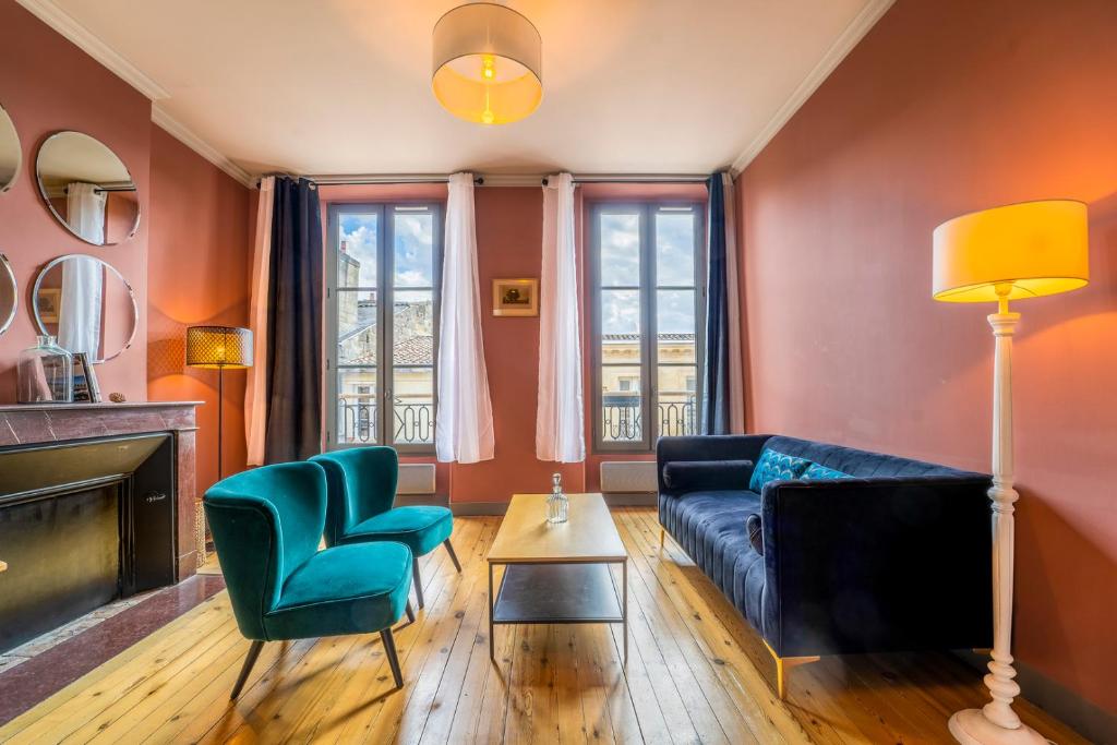 un salon avec un canapé, une table et des chaises dans l'établissement Magnifique Appartement en Hypercentre avec Parking, à Bordeaux