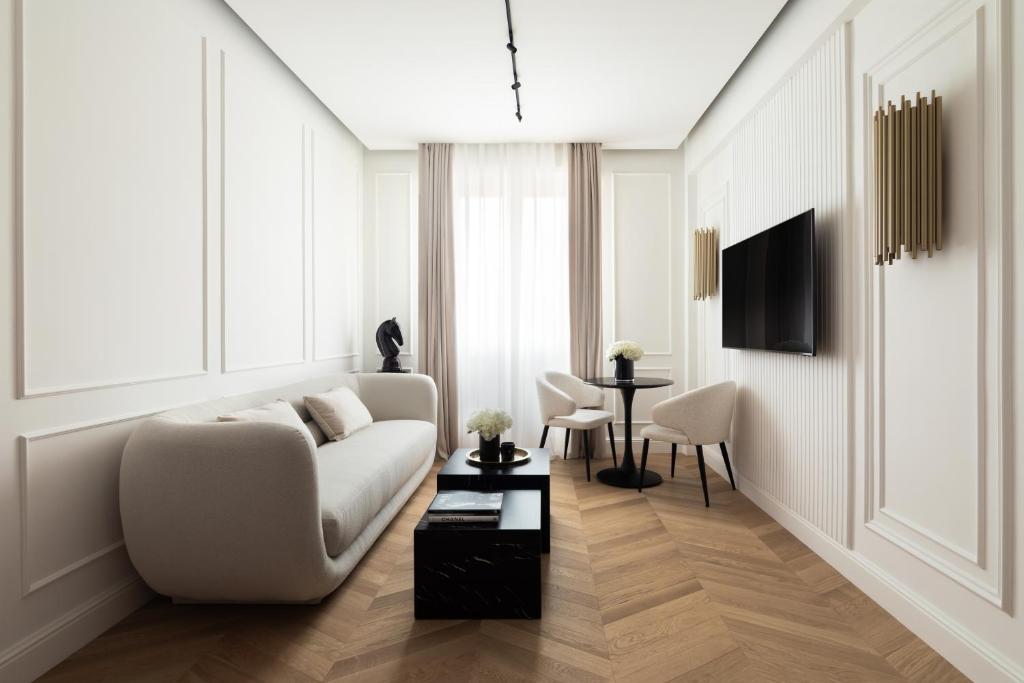 a living room with a white couch and a table at Flòris Luxury Apartment NEW in Florence