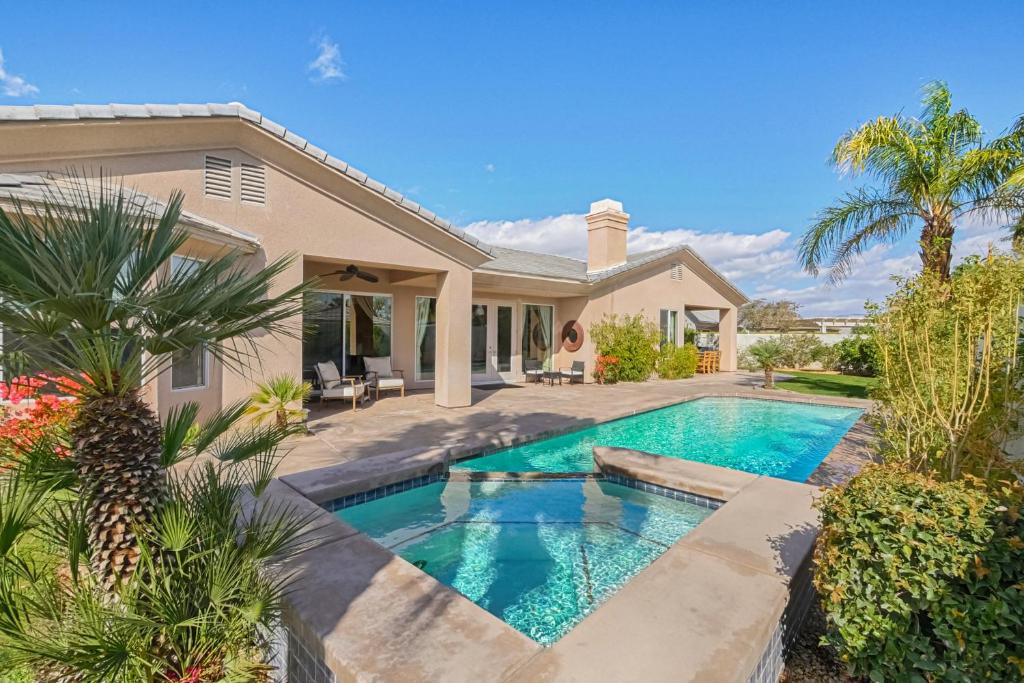 a swimming pool in the backyard of a house at Versailles Vista in Rancho Mirage