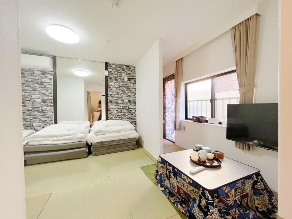 Giường trong phòng chung tại Hananosato Akabane - Vacation STAY 06096v