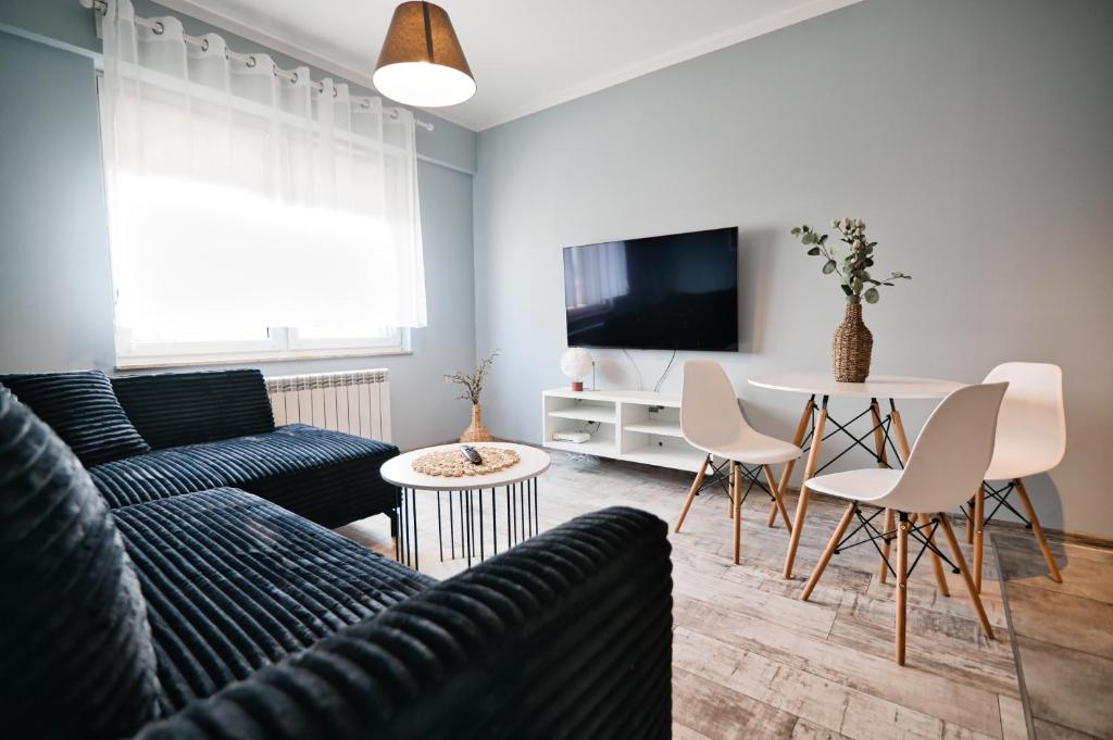 a living room with a couch and a table at ApartClaudia by Housine in Zator
