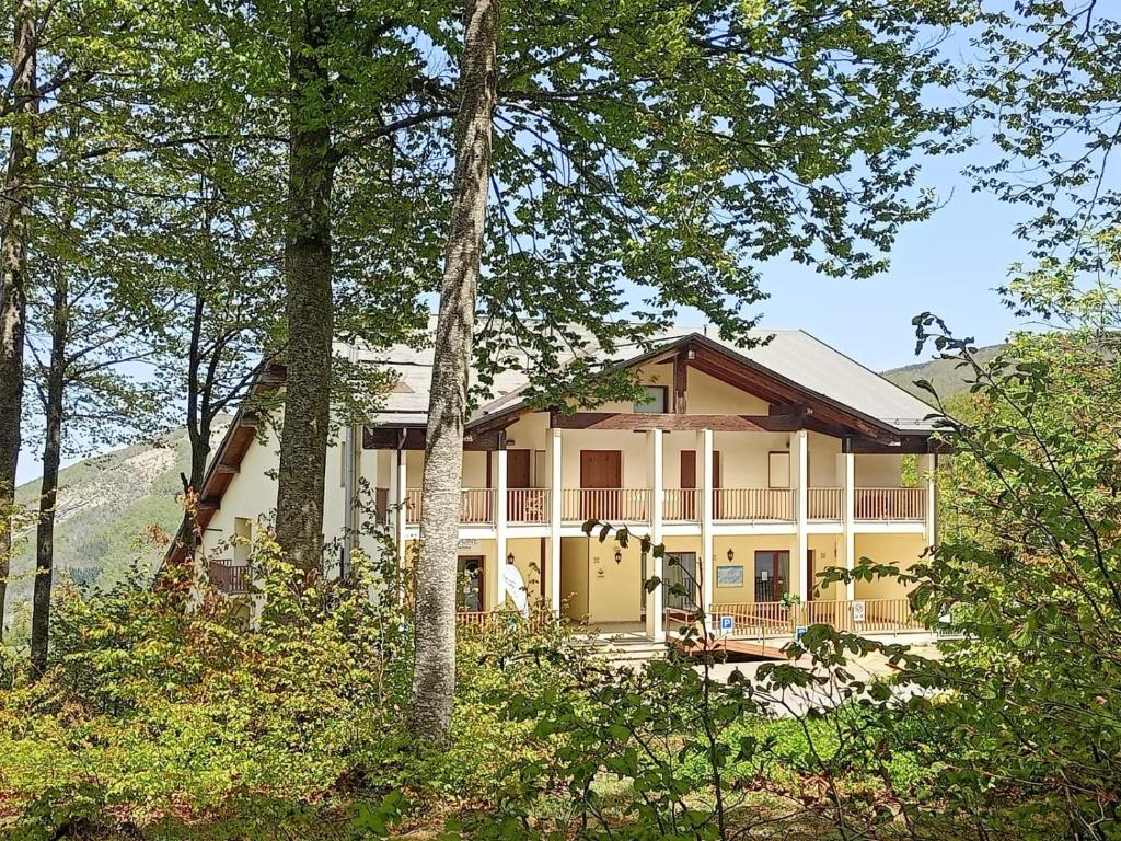 a large house in the middle of the woods at Residence Cimone SuperSci Polle-life in Riolunato
