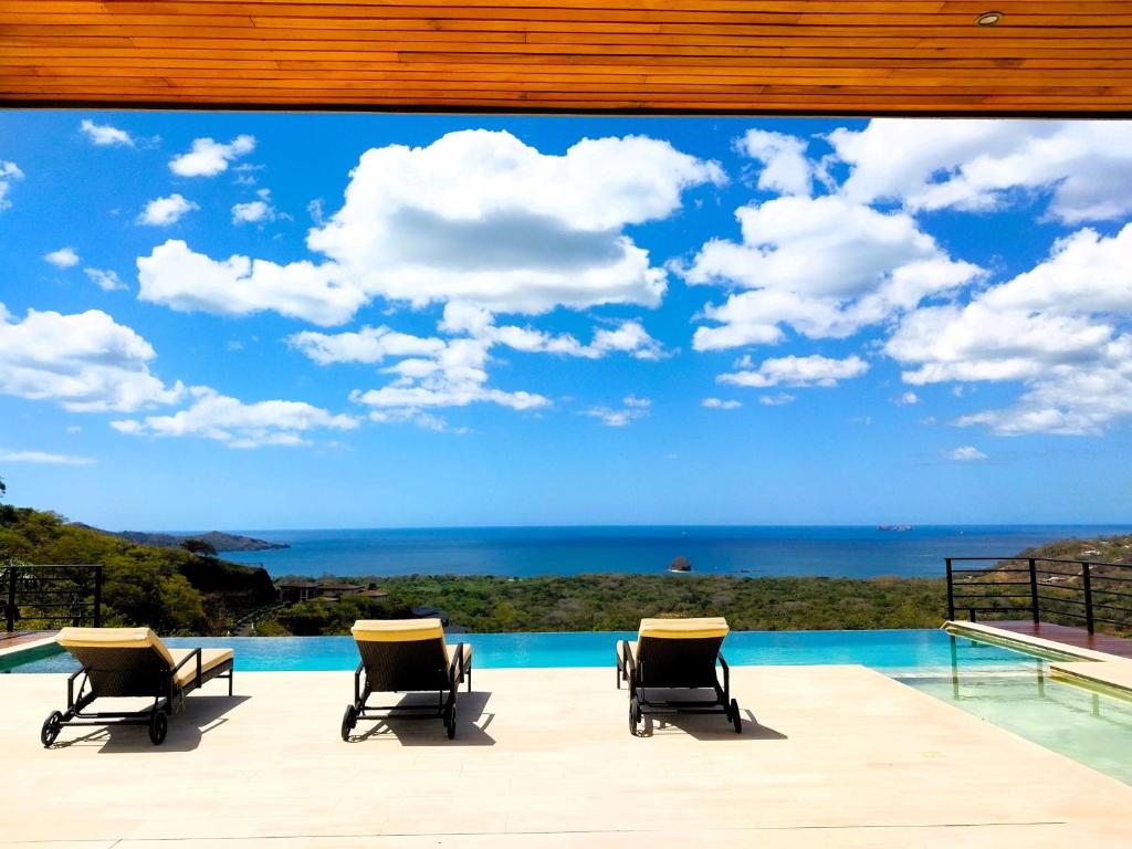 a view of the ocean from the patio of a house at Casa de Iluminacion - Gorgeous 5-BR oceanview Villa with private infinity Pool in Brasilito